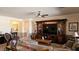 A cozy living room with a ceiling fan and a large entertainment center at 5772 Flying Birdie Ave, Las Vegas, NV 89122