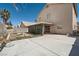Spacious backyard featuring a large patio area and stone barbecue, perfect for outdoor gatherings at 5921 Royal Castle Ln, Las Vegas, NV 89130