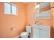 Bathroom with a sink, toilet, mirror, and a window at 5921 Royal Castle Ln, Las Vegas, NV 89130