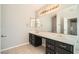 Bathroom featuring double sinks and a large mirror at 5921 Royal Castle Ln, Las Vegas, NV 89130