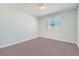 Bright bedroom with fresh white walls and plush carpeting, illuminated by natural light streaming through the window at 5921 Royal Castle Ln, Las Vegas, NV 89130