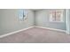 Bright bedroom with neutral paint, carpet, and dual windows at 5921 Royal Castle Ln, Las Vegas, NV 89130