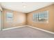 Bedroom featuring neutral paint, carpet, and large dual windows at 5921 Royal Castle Ln, Las Vegas, NV 89130