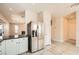 Kitchen view including stainless steel refrigerator, white cabinets, and tiled floor at 5921 Royal Castle Ln, Las Vegas, NV 89130