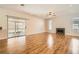 Open-concept living room with hardwood floors, fireplace, and access to the patio at 5921 Royal Castle Ln, Las Vegas, NV 89130