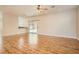 Open living room with hardwood floors, ceiling fan, and access to the backyard patio at 5921 Royal Castle Ln, Las Vegas, NV 89130