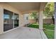 Covered back patio leading to a grassy yard, perfect for outdoor entertaining at 6424 Bombax Ct, Las Vegas, NV 89141