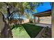 Spacious backyard features artificial turf, a fire pit area, and covered patio at 6424 Bombax Ct, Las Vegas, NV 89141