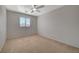 Bedroom with neutral decor featuring ample natural light and a ceiling fan at 6424 Bombax Ct, Las Vegas, NV 89141