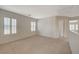 Spacious hallway on the second floor featuring multiple windows, carpet flooring and neutral colors at 6424 Bombax Ct, Las Vegas, NV 89141