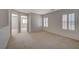 Second floor hallway offers great space with carpet flooring, natural light and access to multiple rooms at 6424 Bombax Ct, Las Vegas, NV 89141