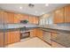 Well-lit kitchen featuring stainless steel appliances, granite countertops, and wood cabinetry at 6424 Bombax Ct, Las Vegas, NV 89141