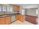 Open kitchen showcases wood cabinets, stainless appliances, granite counters, and connects to dining area at 6424 Bombax Ct, Las Vegas, NV 89141