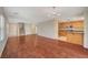 Open-concept living room flows into a kitchen, showcasing hardwood floors and modern lighting at 6424 Bombax Ct, Las Vegas, NV 89141