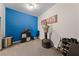 Bedroom with a blue accent wall, neutral carpet, and ample space for furniture at 6955 N Durango Dr # 2031, Las Vegas, NV 89149