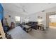 Cozy living room with a comfortable couch, ceiling fan, and access to a balcony at 6955 N Durango Dr # 2031, Las Vegas, NV 89149