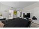A bright main bedroom features an ensuite bath and walk-in closet, and a fun monster poster at 6955 N Durango Dr # 2031, Las Vegas, NV 89149