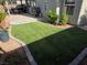 Landscaped backyard featuring artificial turf, a patio, and mature plants at 7136 Overhill, Las Vegas, NV 89129