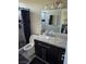 Bathroom featuring a walk-in shower, modern vanity, granite counters, and bright lighting at 7136 Overhill, Las Vegas, NV 89129