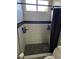 Updated walk-in shower with black tile, black shower curtain, and modern fixtures at 7136 Overhill, Las Vegas, NV 89129