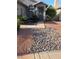 Close-up view of desert landscaping, showing stone beds and plants near the front door and window at 7136 Overhill, Las Vegas, NV 89129