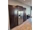 Kitchen pantry cabinets surround a stainless refrigerator with granite counters nearby at 7136 Overhill, Las Vegas, NV 89129