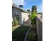 Side yard with artificial turf, stepping stones, landscaping, and privacy wall at 7136 Overhill, Las Vegas, NV 89129