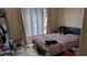 Comfortable bedroom with a large window for natural light, neutral colors, and tile floors at 7155 S Durango Dr # 205, Las Vegas, NV 89113