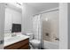 Bright bathroom featuring a shower-tub combo and a single-sink vanity with a wooden base at 7237 Puddle Duck St, Las Vegas, NV 89166