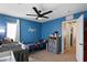 Bright blue bedroom featuring a crib, daybed, and ample storage space at 7237 Puddle Duck St, Las Vegas, NV 89166
