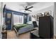 Cozy blue bedroom with a window, gaming setup, and modern decor at 7237 Puddle Duck St, Las Vegas, NV 89166