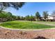 Expansive grassy park area with walking path, trees, and clear blue sky providing a serene outdoor space at 7237 Puddle Duck St, Las Vegas, NV 89166