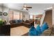 Spacious living room with tile flooring, ceiling fan, and large sectional sofa, perfect for gatherings at 7237 Puddle Duck St, Las Vegas, NV 89166