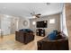 Open-concept living room with comfortable seating, tile flooring, and neutral tones for a cozy atmosphere at 7237 Puddle Duck St, Las Vegas, NV 89166