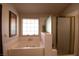 Bathroom features a shower, bathtub, and window at 7660 Descanso Ln, Las Vegas, NV 89123