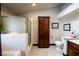Well-lit bathroom featuring bathtub, shower, storage cabinet, toilet, and sink at 7660 Descanso Ln, Las Vegas, NV 89123