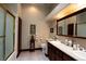 Bathroom featuring double sinks, granite countertops, and tiled shower/tub combo at 7660 Descanso Ln, Las Vegas, NV 89123