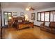 Spacious bedroom with wood floors, ceiling fan, seating area, and natural light at 7660 Descanso Ln, Las Vegas, NV 89123