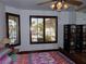 Bedroom featuring large windows with shutters allowing for natural light and backyard views at 7660 Descanso Ln, Las Vegas, NV 89123