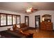 Bedroom features wood floor, natural light, dark wood trim, and a ceiling fan at 7660 Descanso Ln, Las Vegas, NV 89123