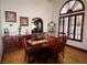 Dining area with wood table, decorative window, and sideboard at 7660 Descanso Ln, Las Vegas, NV 89123