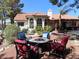 A cozy fire pit area with chairs in a backyard oasis at 7660 Descanso Ln, Las Vegas, NV 89123