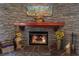 Close up of stone fireplace with wood mantel at 7660 Descanso Ln, Las Vegas, NV 89123