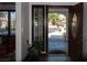 Home's foyer with tile flooring, a wooden front door, and view to front yard at 7660 Descanso Ln, Las Vegas, NV 89123