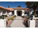 Home's elegant entrance with stone walkway, mature plants, and decorative lighting at 7660 Descanso Ln, Las Vegas, NV 89123