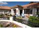 The home's porch featuring desert landscaping, a terracotta roof, and outdoor seating at 7660 Descanso Ln, Las Vegas, NV 89123