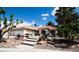 Charming single-story home featuring desert landscaping with mature trees and a tile roof at 7660 Descanso Ln, Las Vegas, NV 89123