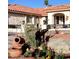 A home's front yard featuring desert landscaping, a terracotta roof, and ornate decorations at 7660 Descanso Ln, Las Vegas, NV 89123