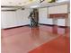 Garage featuring epoxy flooring and generous storage with custom cabinets and a workstation at 7660 Descanso Ln, Las Vegas, NV 89123