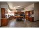 Open concept kitchen with wood cabinets, stainless appliances, and island with bar seating at 7660 Descanso Ln, Las Vegas, NV 89123
